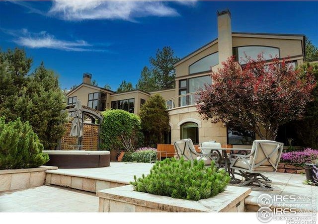 45 Bellevue Dr, Boulder, CO 80302 - view of front facade with a patio area, a balcony, and a chimney