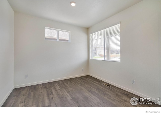 250 Chardon Ave, Brighton, CO 80601 - spare room featuring dark wood-style floors and baseboards