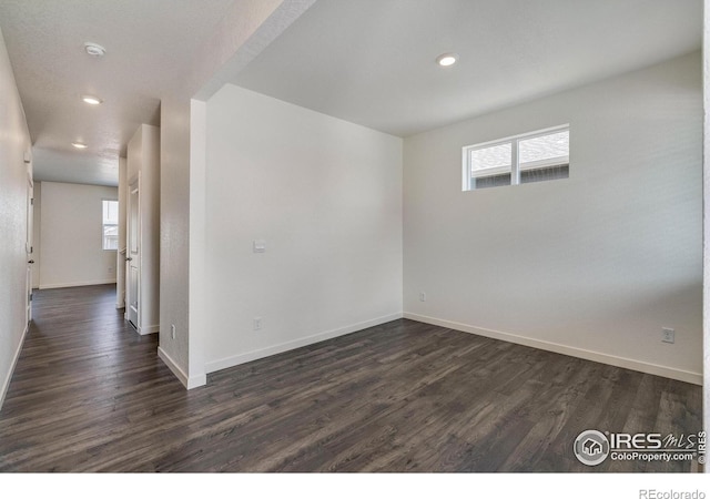 250 Chardon Ave, Brighton, CO 80601 - spare room with dark wood-style flooring, healthy amount of natural light, baseboards, and recessed lighting