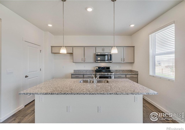 250 Chardon Ave, Brighton, CO 80601 - kitchen featuring stainless steel appliances, a sink, gray cabinets, dark wood finished floors, and baseboards