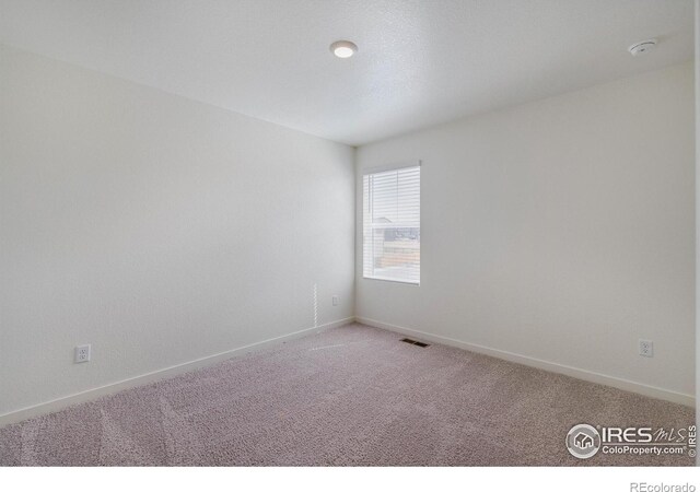250 Chardon Ave, Brighton, CO 80601 - unfurnished room featuring light colored carpet, baseboards, and a smoke detector