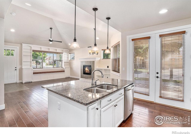 4751 Pleasant Oak Dr Unit A28, Fort Collins, CO 80525 - kitchen with a sink, dishwasher, a tile fireplace, french doors, and dark wood-style flooring
