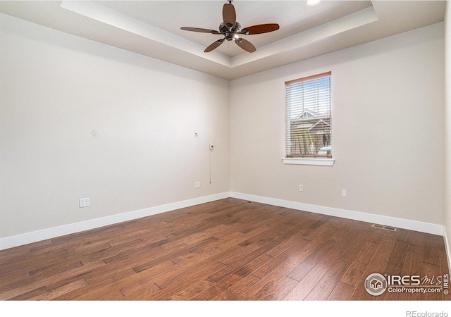 4751 Pleasant Oak Dr Unit A28, Fort Collins, CO 80525 - unfurnished room with a raised ceiling, wood finished floors, a ceiling fan, and baseboards