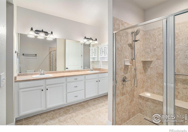 4751 Pleasant Oak Dr Unit A28, Fort Collins, CO 80525 - bathroom with a shower stall, double vanity, and tile patterned flooring