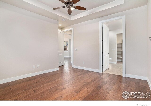 4751 Pleasant Oak Dr Unit A28, Fort Collins, CO 80525 - unfurnished bedroom featuring wood finished floors, baseboards, a raised ceiling, recessed lighting, and ceiling fan