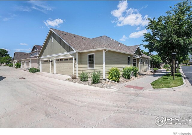 4751 Pleasant Oak Dr Unit A28, Fort Collins, CO 80525 - view of home's exterior featuring a shingled roof, driveway, and an attached garage