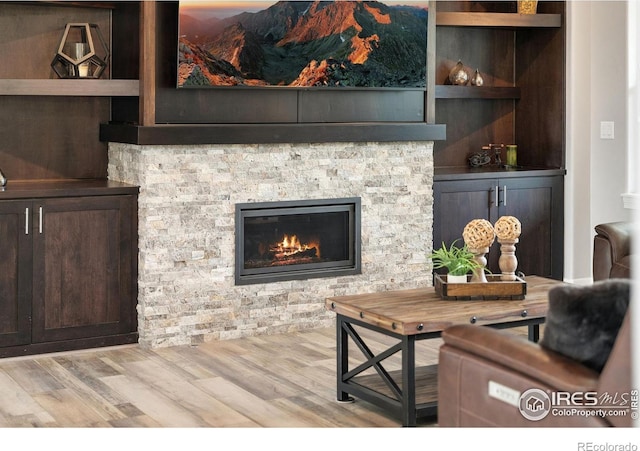 5966 Sunny Crest Dr, Timnath, CO 80547 - living area with wood finished floors and a stone fireplace