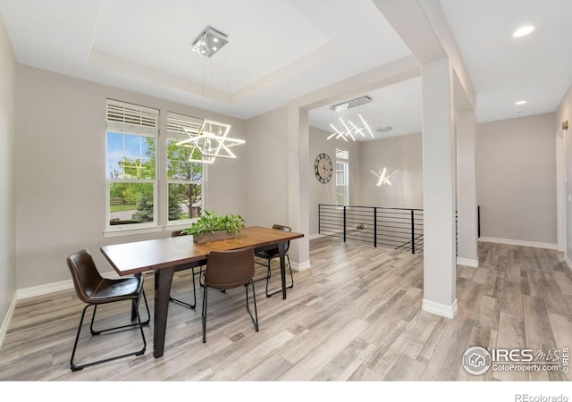 5966 Sunny Crest Dr, Timnath, CO 80547 - dining space with a chandelier, light wood finished floors, baseboards, a raised ceiling, and recessed lighting