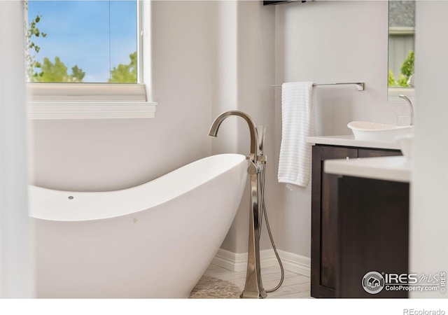 5966 Sunny Crest Dr, Timnath, CO 80547 - bathroom with vanity, a freestanding tub, and baseboards