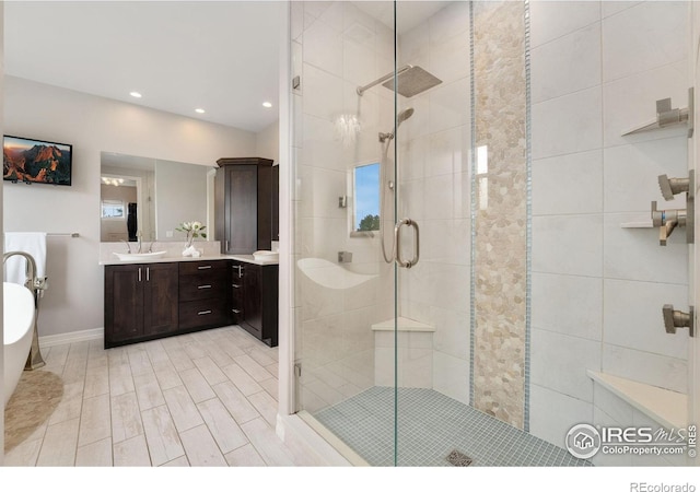 5966 Sunny Crest Dr, Timnath, CO 80547 - bathroom featuring a stall shower, vanity, recessed lighting, a soaking tub, and baseboards