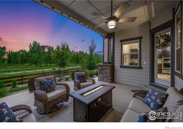 5966 Sunny Crest Dr, Timnath, CO 80547 - patio terrace at dusk with a fire pit, a ceiling fan, and a patio