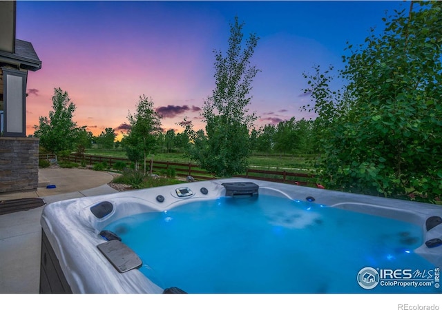 5966 Sunny Crest Dr, Timnath, CO 80547 - pool at dusk with a hot tub