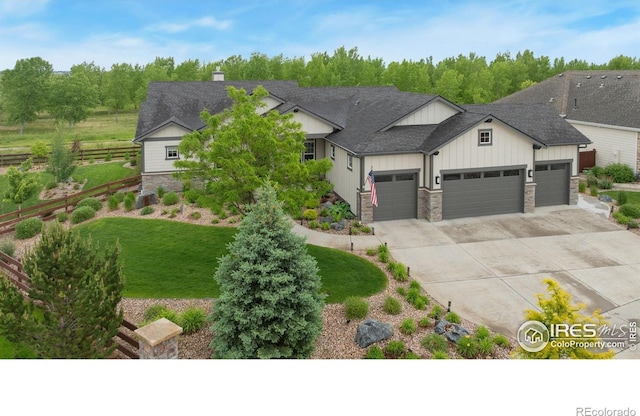 5966 Sunny Crest Dr, Timnath, CO 80547 - view of front of property featuring an attached garage, board and batten siding, stone siding, and driveway