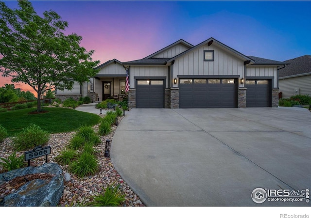 5966 Sunny Crest Dr, Timnath, CO 80547 - craftsman-style house featuring board and batten siding, a garage, driveway, stone siding, and a front yard