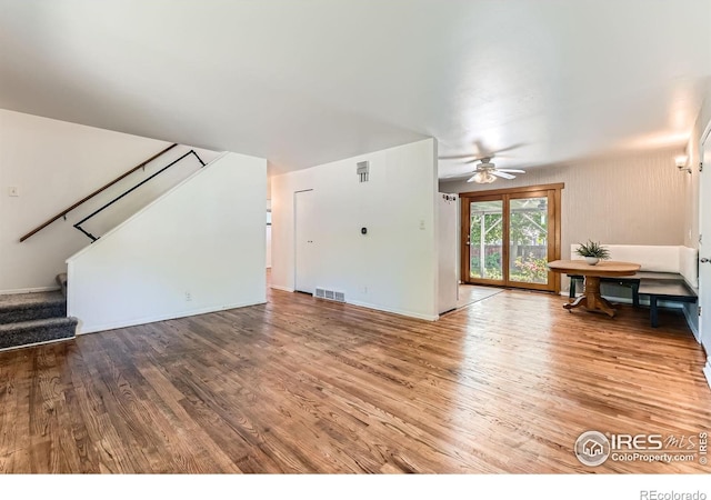 510 S 46th St, Boulder, CO 80305 - unfurnished living room with wood finished floors, ceiling fan, stairs, and baseboards