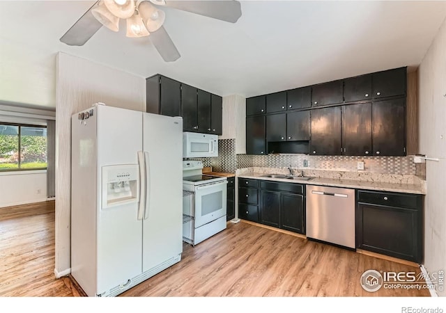 510 S 46th St, Boulder, CO 80305 - kitchen featuring white appliances, light wood-style floors, a sink, light countertops, and backsplash