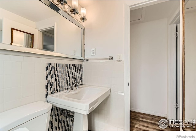 510 S 46th St, Boulder, CO 80305 - bathroom with tile walls, toilet, wood finished floors, and decorative backsplash