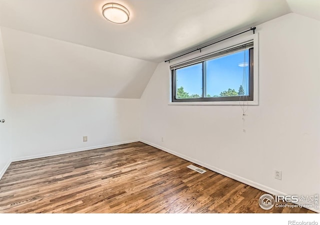 510 S 46th St, Boulder, CO 80305 - additional living space with vaulted ceiling, baseboards, and wood finished floors