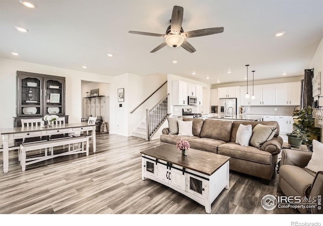 12889 Clearview St, Firestone, CO 80504 - living room featuring stairway, light wood-type flooring, recessed lighting, and a ceiling fan