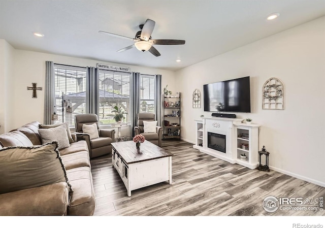 12889 Clearview St, Firestone, CO 80504 - living area featuring a ceiling fan, wood finished floors, and recessed lighting