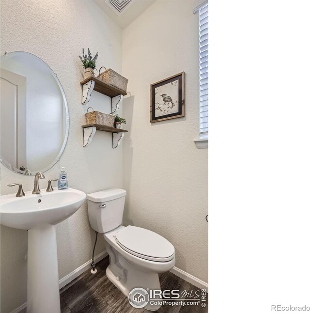 12889 Clearview St, Firestone, CO 80504 - half bath featuring toilet and wood finished floors