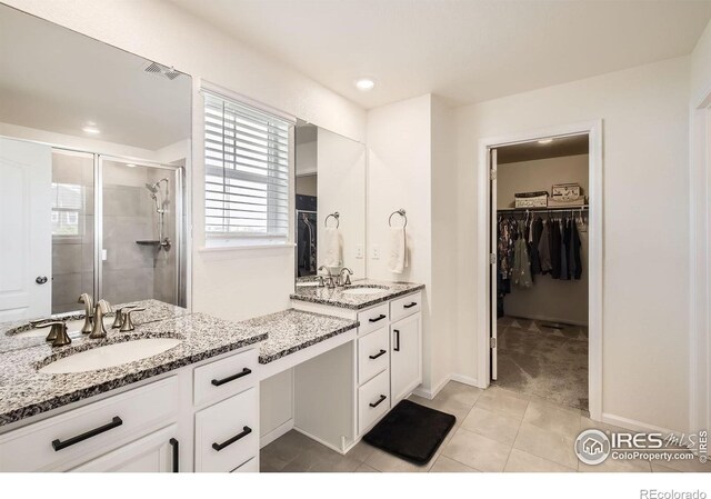 12889 Clearview St, Firestone, CO 80504 - bathroom featuring a stall shower, vanity, a spacious closet, tile patterned floors, and recessed lighting