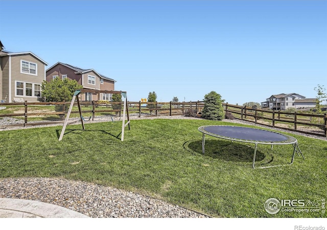 12889 Clearview St, Firestone, CO 80504 - fenced backyard with a trampoline and a playground