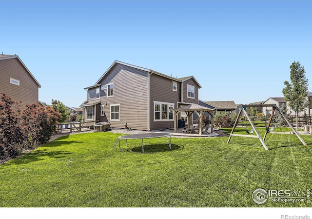 12889 Clearview St, Firestone, CO 80504 - rear view of house featuring a gazebo, a lawn, a playground, and a patio area