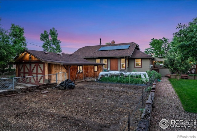 4900 W 6th Ave, Denver, CO 80204 - view of front facade featuring roof mounted solar panels and a chimney