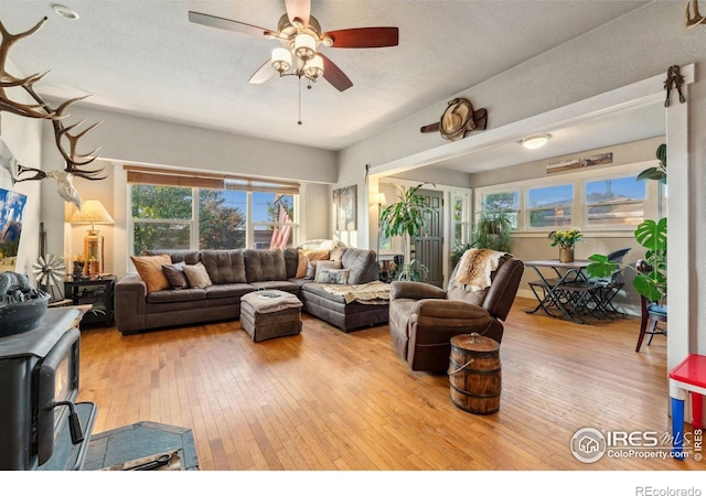 4900 W 6th Ave, Denver, CO 80204 - living room featuring hardwood / wood-style flooring, a wood stove, and ceiling fan