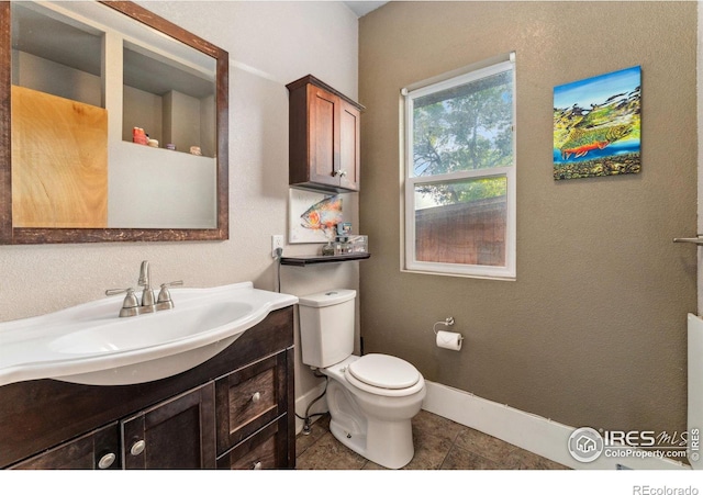 4900 W 6th Ave, Denver, CO 80204 - bathroom with vanity, toilet, baseboards, and tile patterned floors