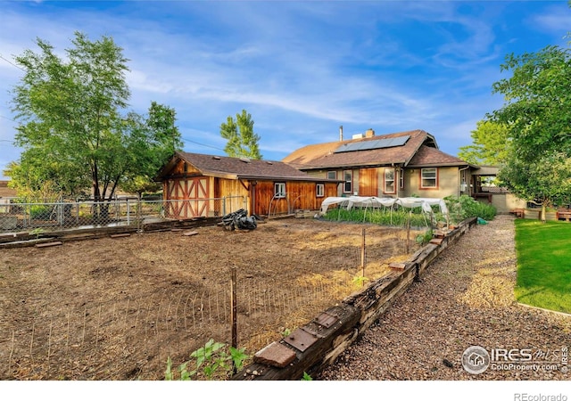 4900 W 6th Ave, Denver, CO 80204 - rear view of property with solar panels and a fenced backyard