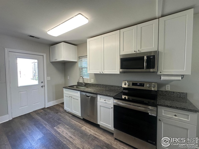 611 N 2nd St, Sterling, CO 80751 - kitchen with stainless steel appliances, a sink, and white cabinetry
