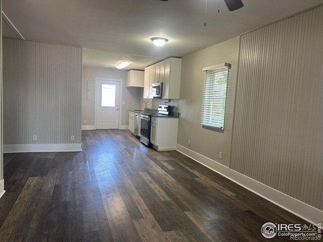 611 N 2nd St, Sterling, CO 80751 - kitchen featuring stainless steel appliances, dark wood-type flooring, a sink, white cabinets, and ceiling fan