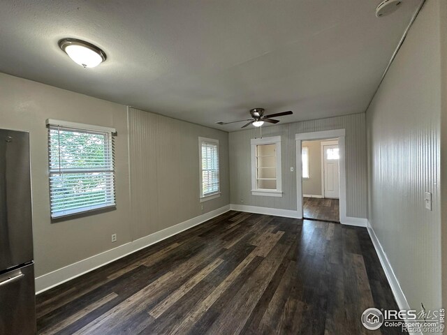 611 N 2nd St, Sterling, CO 80751 - spare room featuring dark wood finished floors, baseboards, and ceiling fan
