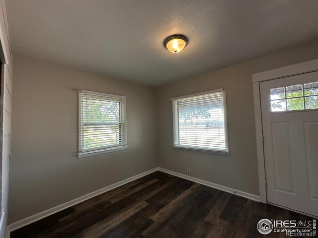 611 N 2nd St, Sterling, CO 80751 - entrance foyer with healthy amount of natural light and dark wood finished floors
