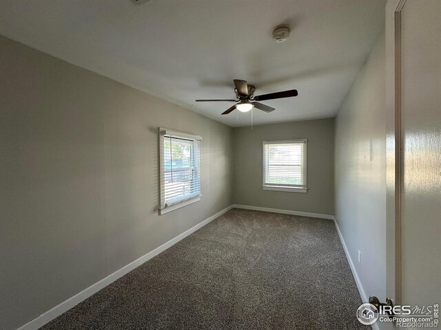 611 N 2nd St, Sterling, CO 80751 - carpeted empty room featuring a ceiling fan, a smoke detector, and baseboards