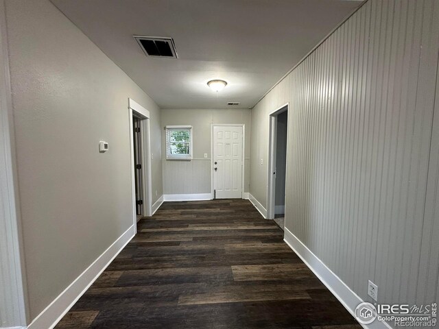 611 N 2nd St, Sterling, CO 80751 - corridor featuring dark wood-style flooring and baseboards