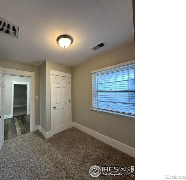 611 N 2nd St, Sterling, CO 80751 - unfurnished bedroom with baseboards and carpet floors