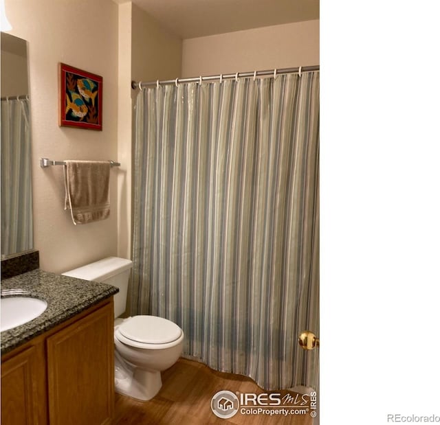 4985 Twin Lakes Rd Unit 94, Boulder, CO 80301 - bathroom with vanity, wood finished floors, toilet, and a shower with curtain
