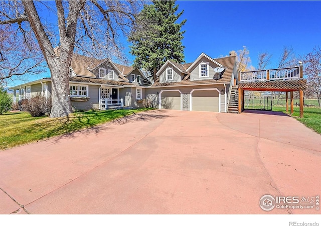 2994 75th St, Boulder, CO 80301 - view of front of home featuring an attached garage, a front yard, driveway, and a wooden deck