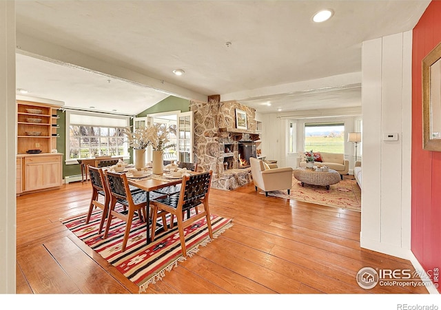 2994 75th St, Boulder, CO 80301 - dining room with light wood finished floors, plenty of natural light, a baseboard radiator, a fireplace, and recessed lighting