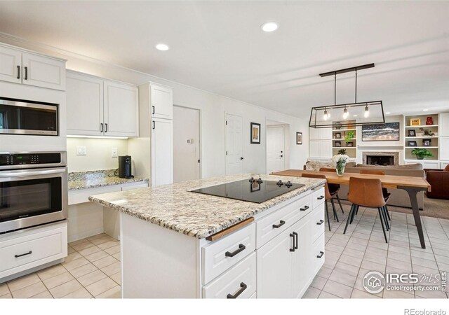 4483 S Meadow Dr, Boulder, CO 80301 - kitchen with appliances with stainless steel finishes, light tile patterned floors, open floor plan, a center island, and white cabinetry