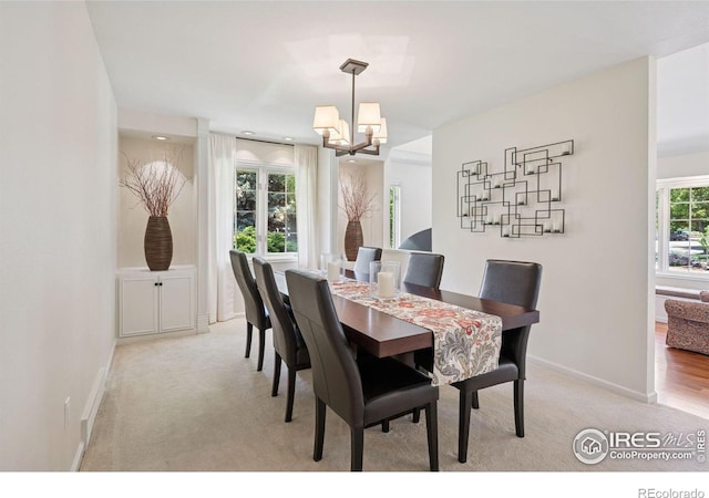 4483 S Meadow Dr, Boulder, CO 80301 - dining room featuring light carpet, a chandelier, and baseboards