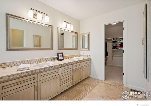 4483 S Meadow Dr, Boulder, CO 80301 - bathroom featuring double vanity, a spacious closet, baseboards, and tile patterned floors