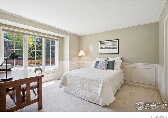 4483 S Meadow Dr, Boulder, CO 80301 - bedroom with light colored carpet, a decorative wall, and wainscoting