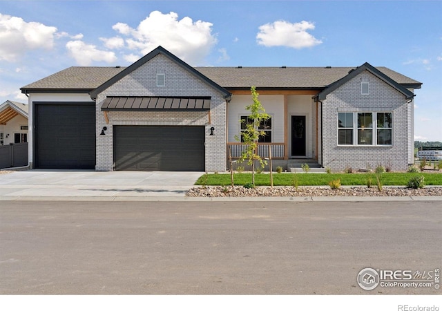 1425 Burt Ave, Berthoud, CO 80513 - modern inspired farmhouse with a garage, concrete driveway, and brick siding