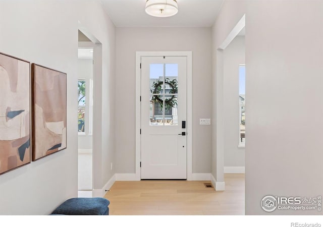 1425 Burt Ave, Berthoud, CO 80513 - foyer with wood finished floors, plenty of natural light, and baseboards