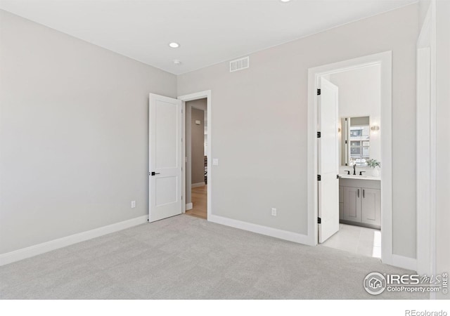 1425 Burt Ave, Berthoud, CO 80513 - unfurnished bedroom featuring light colored carpet, baseboards, ensuite bath, recessed lighting, and a sink