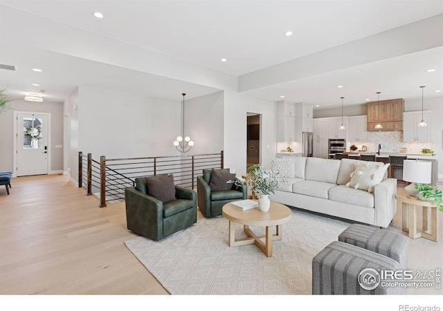 1425 Burt Ave, Berthoud, CO 80513 - living room featuring light wood-type flooring, a chandelier, and recessed lighting
